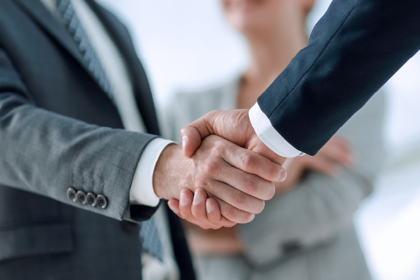 peoples arms shaking hands