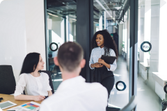 a lady holding a clipboard talking to others